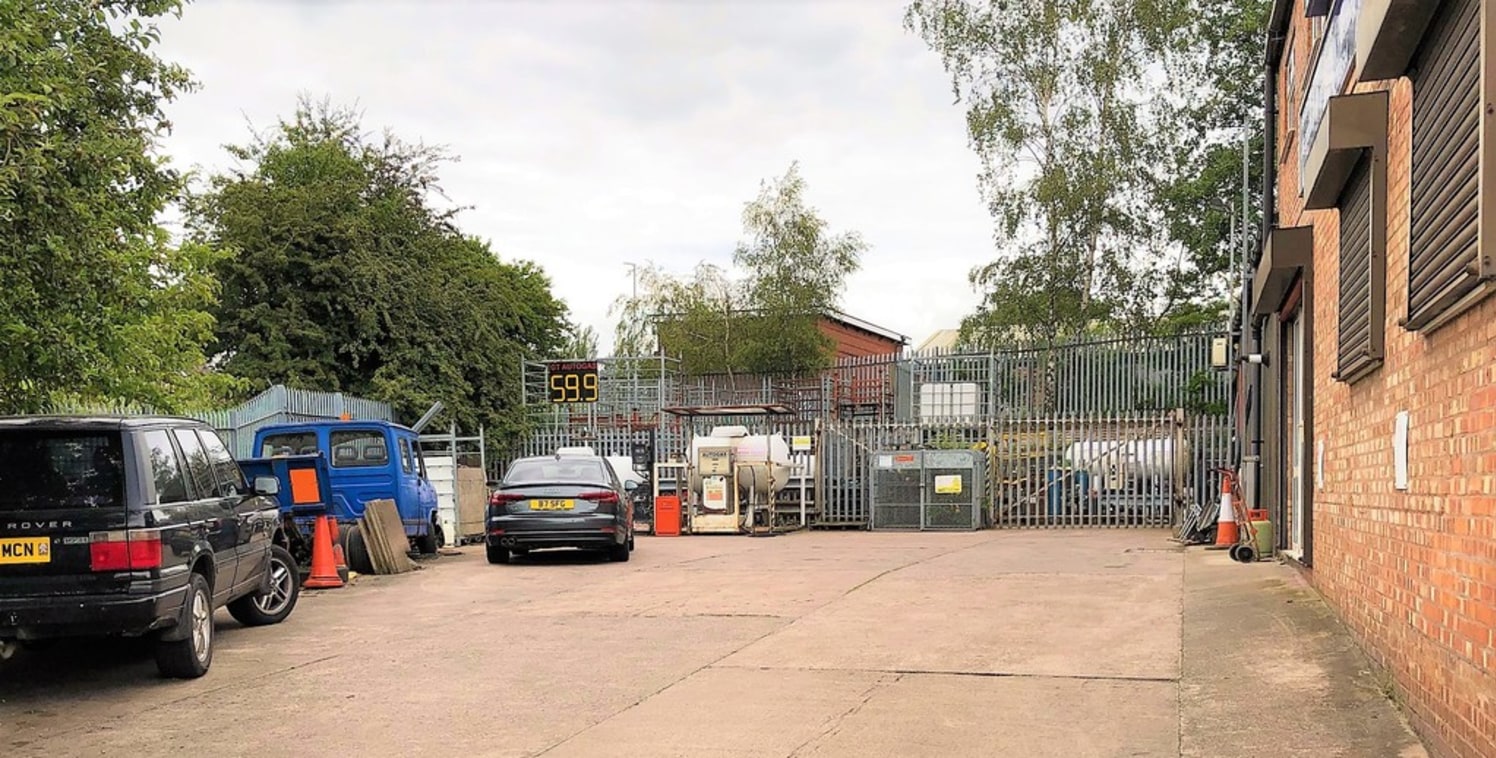 A steel framed building comprising a two storey trade counter/office block to the front of brick and clad elevations with adjoining workshop/warehouse to the rear with two roller shutter loading doors and profile clad elevations.