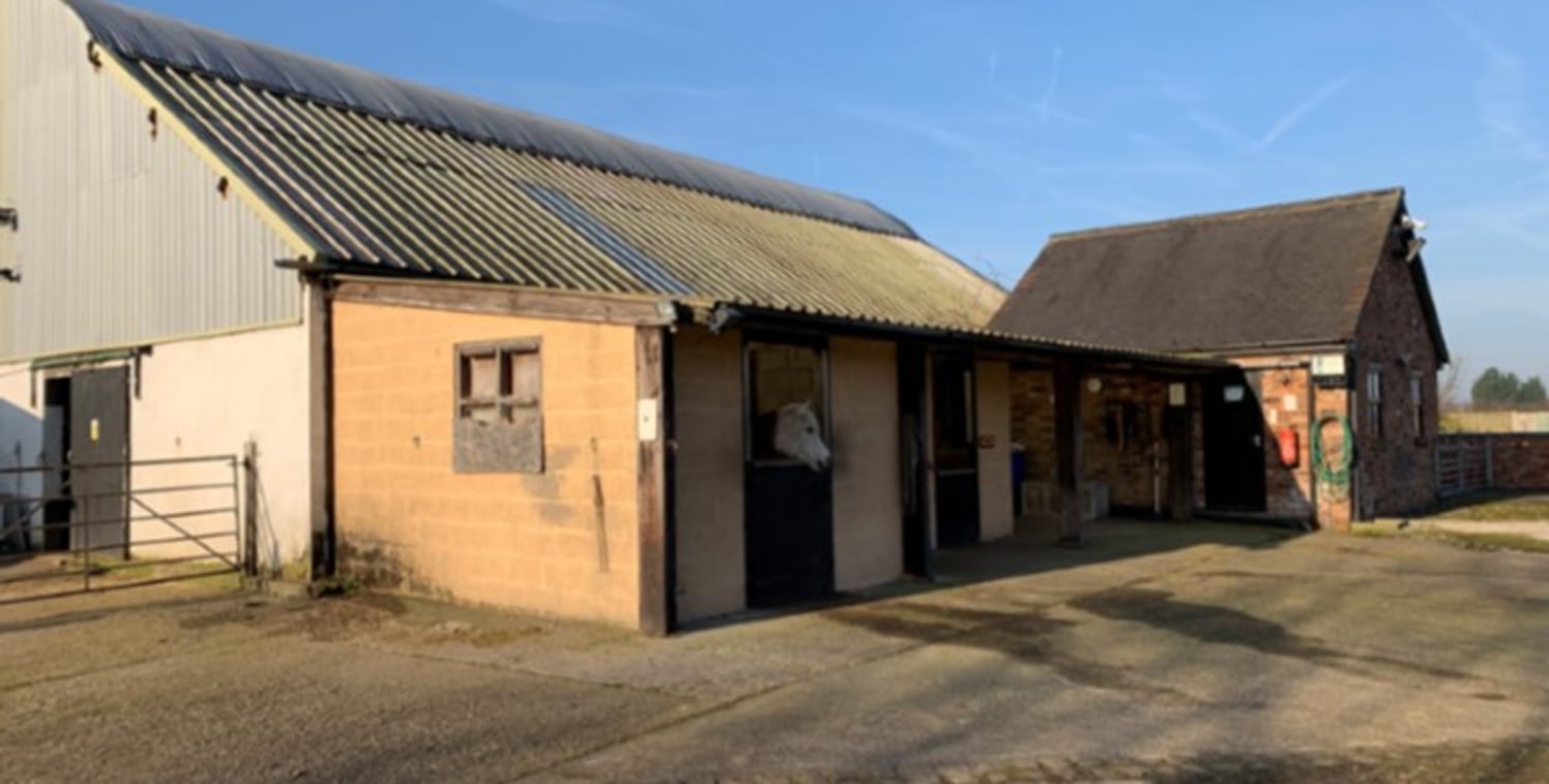 We are pleased to offer for sale a rare opportunity to acquire; a small holding of land, timber and blockwork stables, ménage, various outbuildings together with a semi-detached Dutch barn that benefits from a B1 use classification.

The total site a...