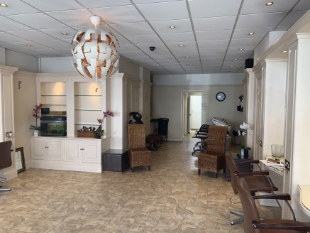 A well proportioned lock up shop currently trading as a ladies hair salon and fitted out to provide a front salon, with ancillary treatment room, office, kitchen and WC. The floor area of the shop is 796 sq ft and to the rear there is parking for 3-4...