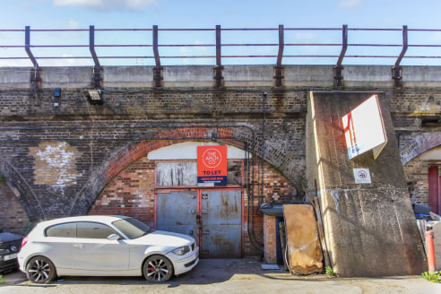 This arch has a brick infill to the front facing Belinda Road with a concertina door and a brick infill to the rear leading onto a block built rear extension. The arch has a concrete floor with electricity supply but no power connection which would b...