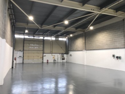 A modern single storey warehouse unit benefitting from the following:\n\n* 5.14m eaves\n* high quality offices\n* large shared yard with separate car parking\n* heating and lighting to both the offices and warehouse space\n* level access loading via...