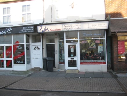 A mid terrace building which comprises of a lock-up shop with rear stores. To the rear and at first-floor level are three self-contained flats which have been sold off on long leases.