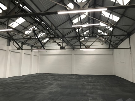 A modern single storey warehouse unit benefitting from high quality single storey offices, ladies and gents W/Cs and a single drive in level access...