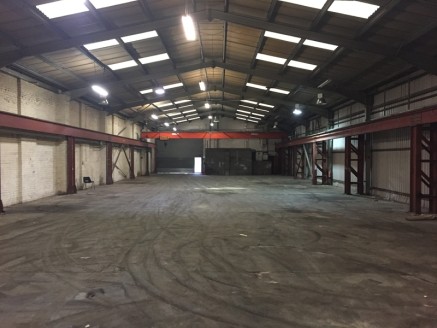 The property is of a steel portal frame construction beneath a pitched lined roof, incorporating intermittent translucent roof lighting. The front of the premises are made up of first storey offices providing a mixture of cellular and open plan offic...