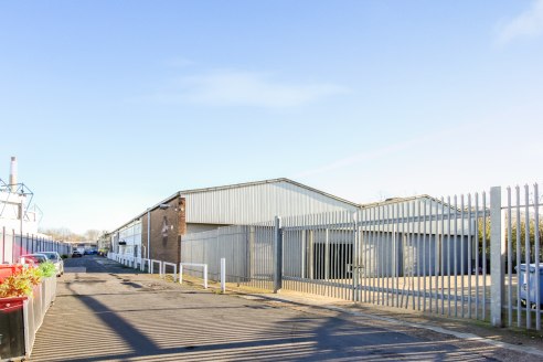 The property comprises a main warehouse built of concrete portal frame construction with brick and clad elevations with access via two roller shutters, ancillary ground and first floor offices and a covered loading bay accessible via six roller shutt...
