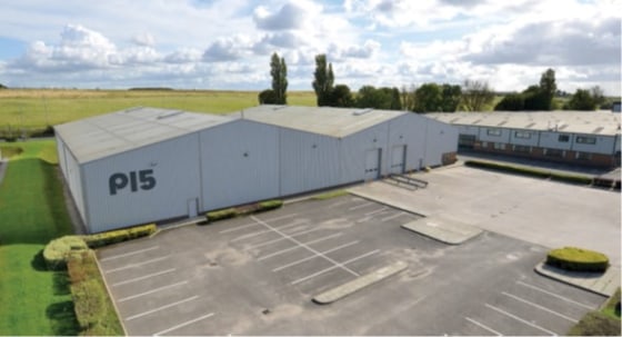 Steel portal frame construction. 2 bay interconnecting warehouse. 6.5m to eaves, 6m to underside haunch. Ground floor offices. High bay sodium box lighting. 2 no. drive-in loading doors. Mezzanine flooor. Suspended warm air blower heaters. Generous y...