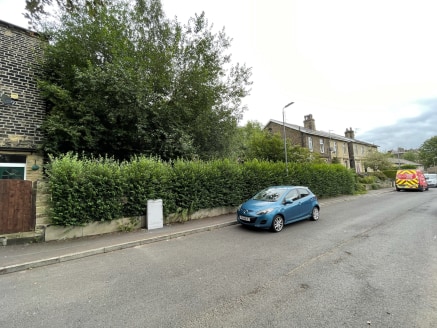 The land is situated in a residential area of Sowerby Bridge with access from both Hollins Lane and Industrial Road due to the sloping topography of the site. The parcel of land is rectangular in shape and gently slopes roughly from North to South. T...