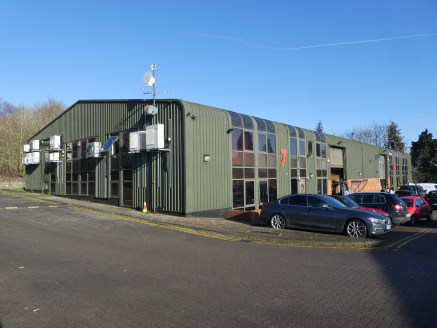 Unit 7 is an end of terrace industrial unit of steel and concrete frame construction with glazing to the front, rear and left hand elevations. The unit benefits from a roller shutter loading door to the front of the building.