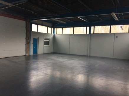 The premises comprise part of a terrace of workshop units which are steel framed with cavity brickwork, glazing and cladding to the external elevations and a flat mono pitched roof with mineral felt covering. 

Internally the units have concrete floo...