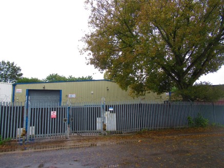 The premises is a single storey, light industrial/warehouse property within a fenced plot.\n\nVehicular access is via a full height roller shutter with personnel door leading directly into the office block.\n\nA front yard is currently used for stora...