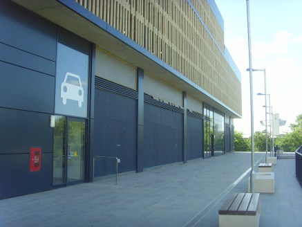 The retail units form the ground floor of the principal parking provision for visitors, and the entire car park scheme forms the first phase of a major comprehensive mixed development of adjoining land (subject to planning).

 The ground floor retail...