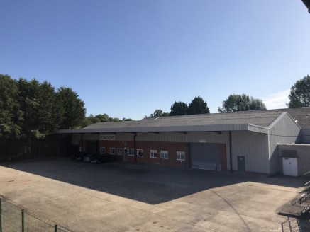 The property comprises a substantial warehouse with brick and steel elevations, two offices, kitchen WC's and shower facilities. The offices benefit from double glazing. The unit has two electrically operated surface level covered loading doors leadi...