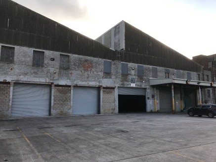 The premises forms a large industrial/warehouse which provides excellent storage/production space benefitting from the following specification:

* Average Clear Headroom 9.5m (31ft)

* Solid Concrete Floor

* Drive in roller shutter loading doors

*...