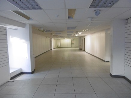 The property provides a large ground floor retail area with ancillary stores above. The unit is fitted with a suspended ceiling and inset lighting with a tiled floor....