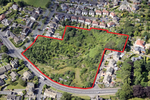 Residential development site occupying an attractive green field setting within a former quarry. The land is immediately to the east of Brighouse High School.