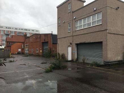 The site totals approximately 1.01 acres (0.41 hectares) and consists of an existing warehouse and office accommodation with a showroom to the front of the site.