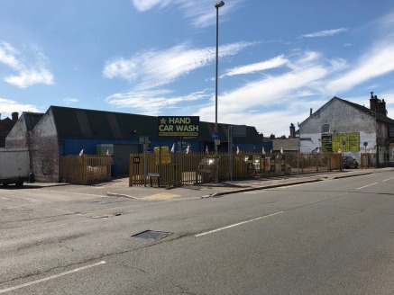 A detached workshop/trade counter unit of brick elevation supporting a steel truss pitched roof surface extending to 4,176 sq.ft. (GIA) together with a well proportioned yard with extensive roadside frontage.