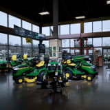 John Deere riding lawnmowers sitting on showroom floor