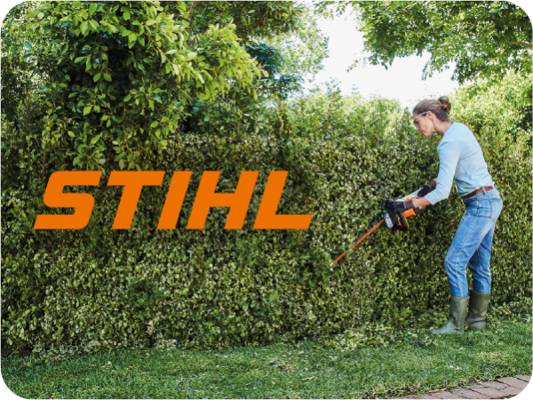 A women trimming hedges with a STIHL hedge trimmer