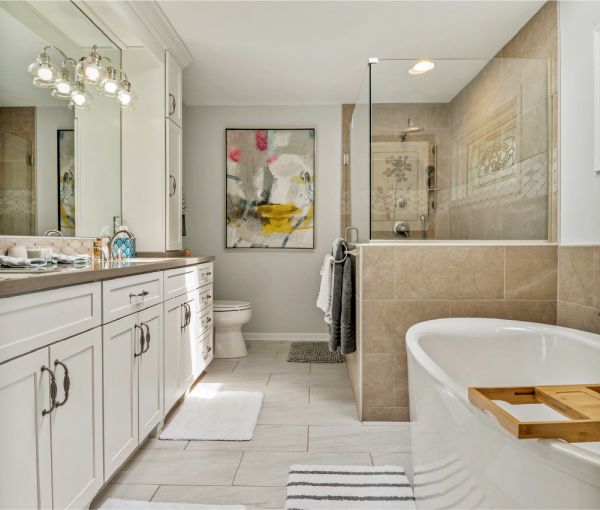 The transitional bathroom with a shower, freestanding tub, white cabinets, and large vanity.