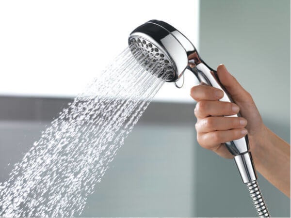 Someone holding a Delta removable showerhead