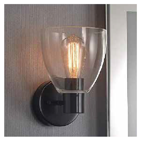 A close-up of a wall sconce on a wall with an illuminated lighbulb.