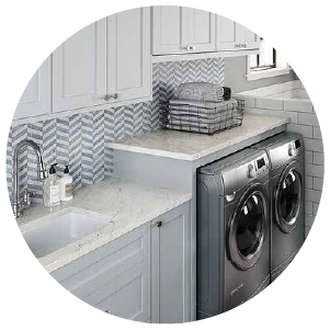 A laundry room with quartz countertops and a washer & dryer set.