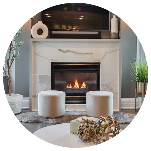 A fireplace in a living room surrounded by quartz with a TV above it.