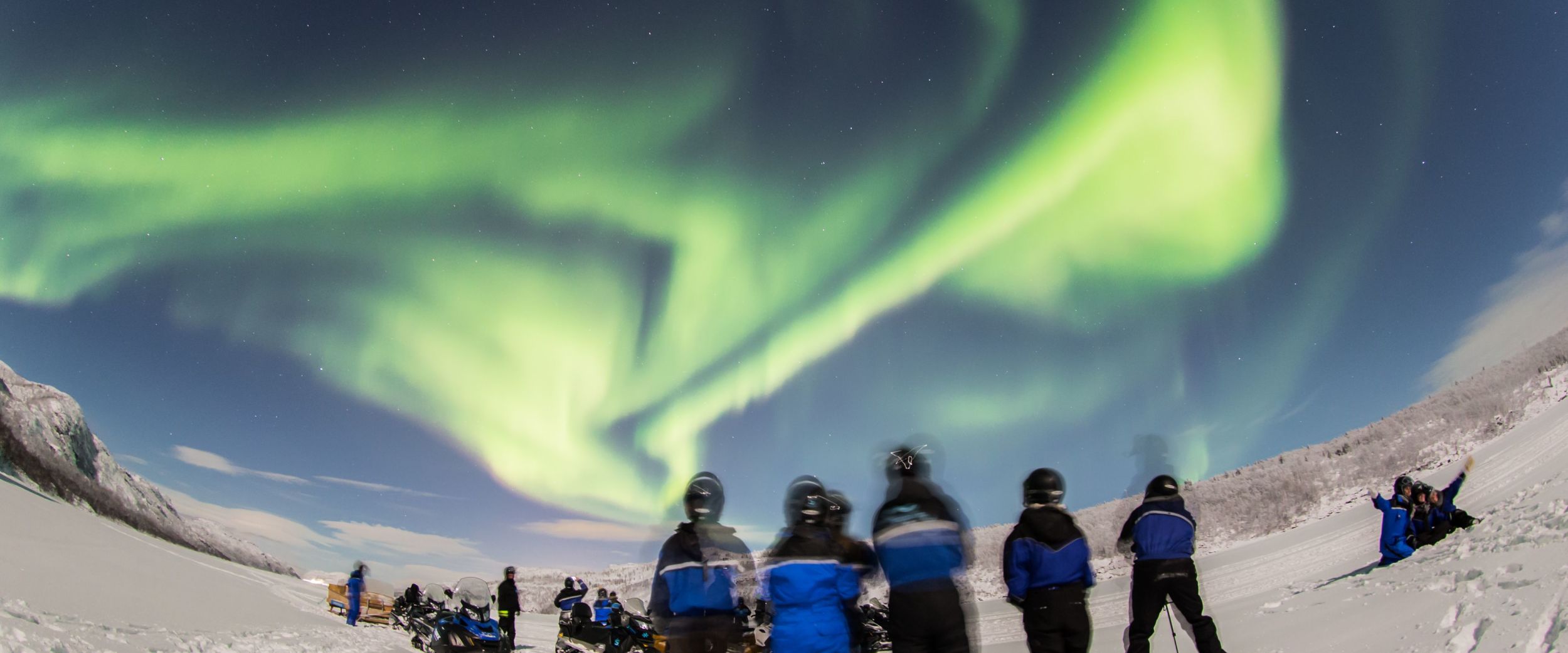 Snowmobiling under the northern lights, photo: Nicolas Vera-Ortiz