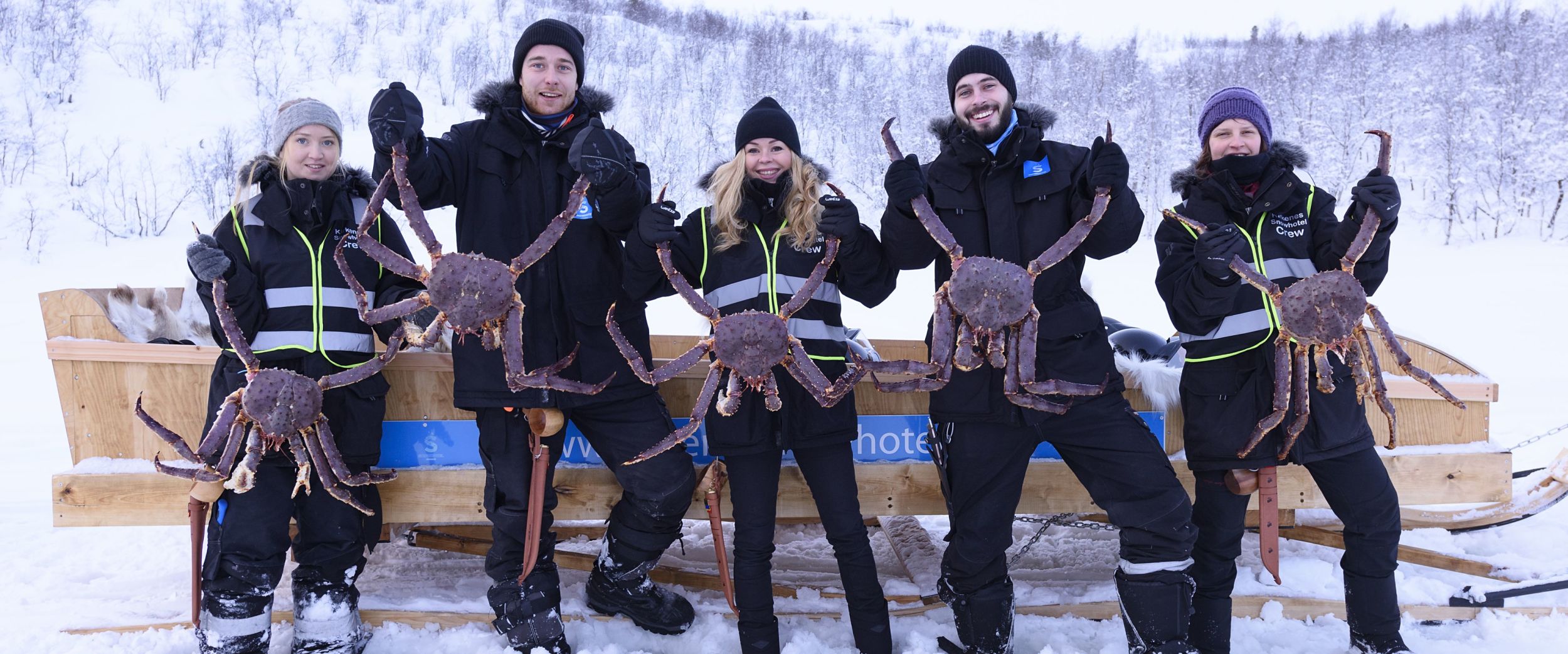 Happy people holding king crabs