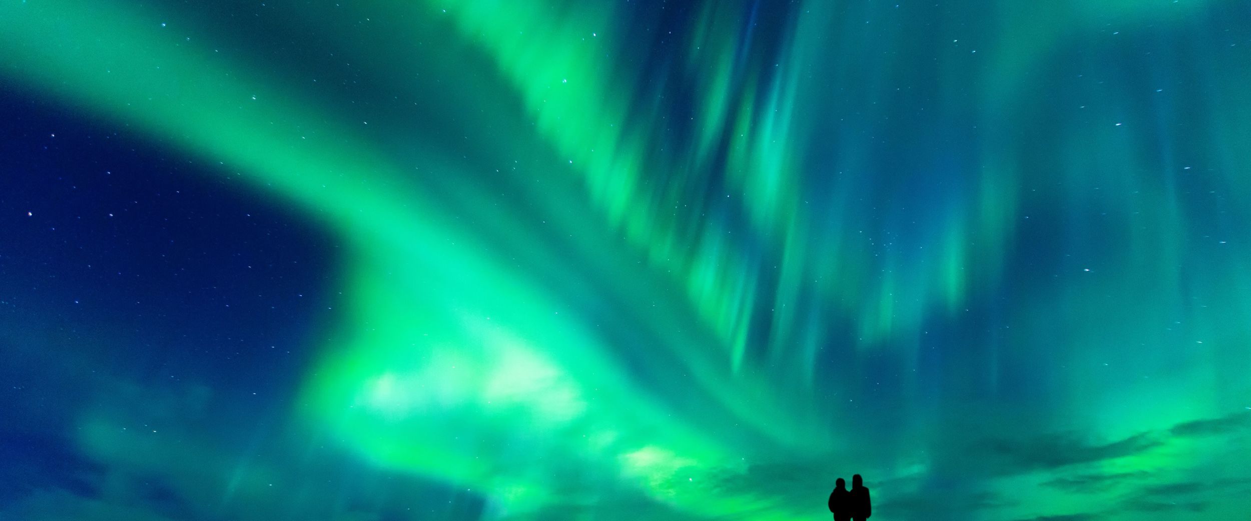 Couple enjoying the Northern Lights. 