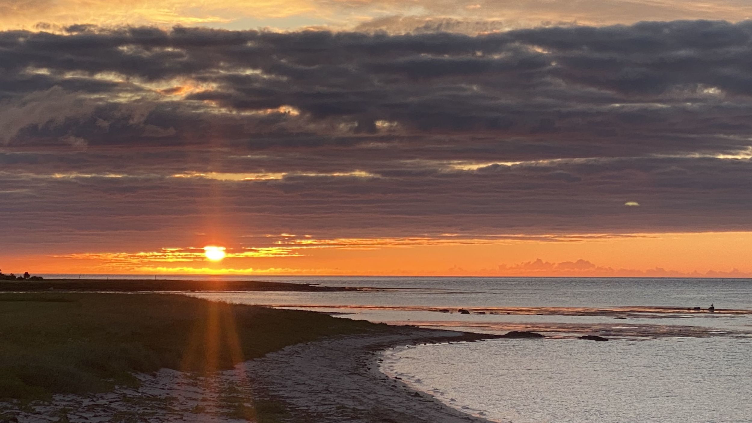 Midnight sun at a beach at Kvalnes in Lofoten