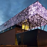 Rockheim museum with purple lightning at night. 