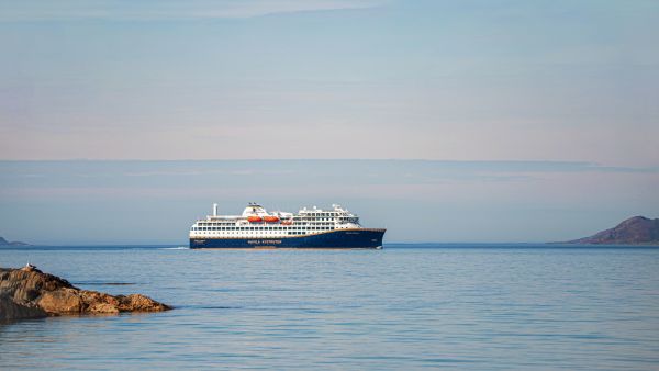 Havila Voyages ship on the ocean horizon 