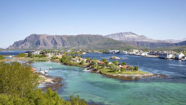 Islands off Brønnøysund with clear green water on a sunny day.