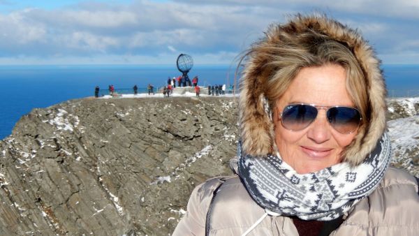 woman at the north cape wearing sunglasses and a scarf