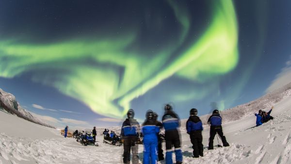 Snowmobiling under the northern lights, photo: Nicolas Vera-Ortiz