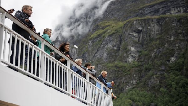 guests in geiranger viewing nature from outside deck