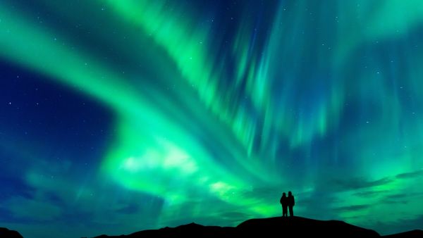 Couple enjoying the Northern Lights. 