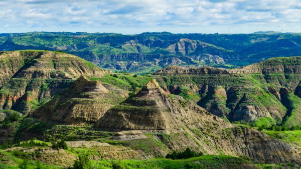 Colorful rock formations and layered hills in Theodore Roosevelt National Park, North Dakota.