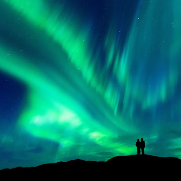 Couple enjoying the Northern Lights. 