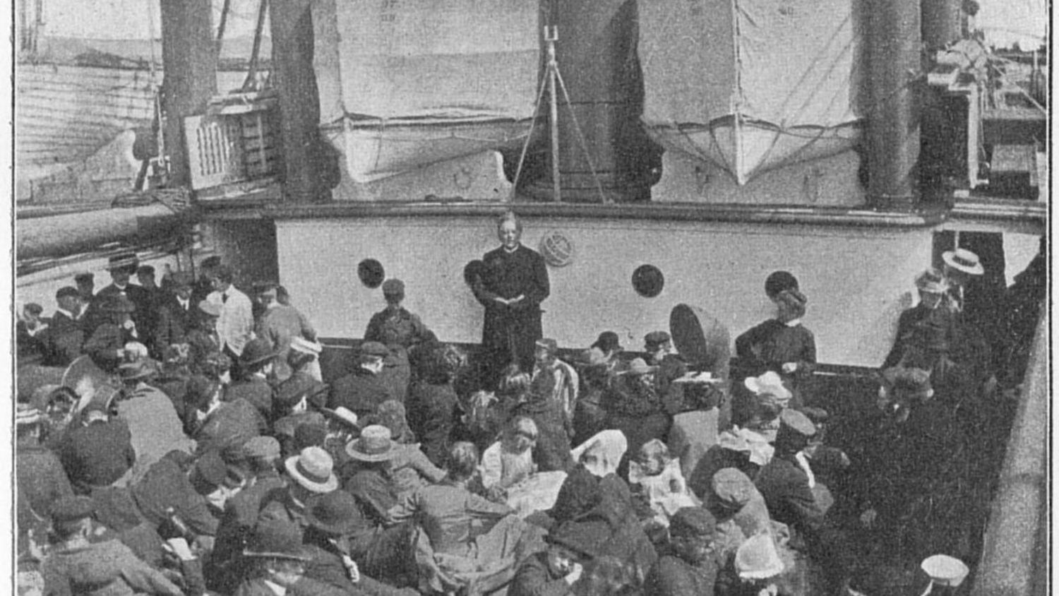 Historic black-and-white photo of Norwegian emigrants gathered on the deck of a ship 