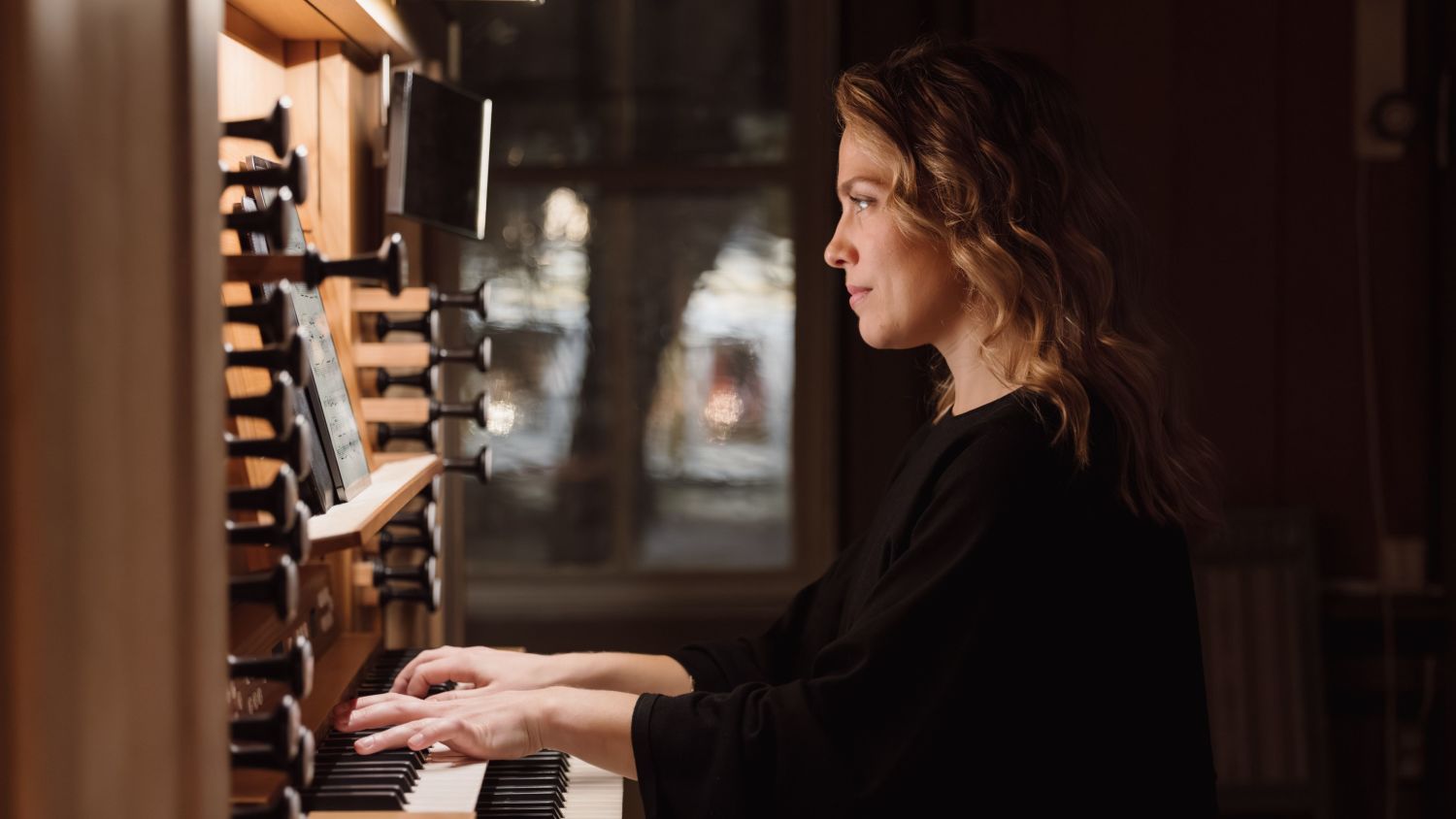 Midnight concert in the Tromsø Cathedral, Norway. Woman playing pipe organ