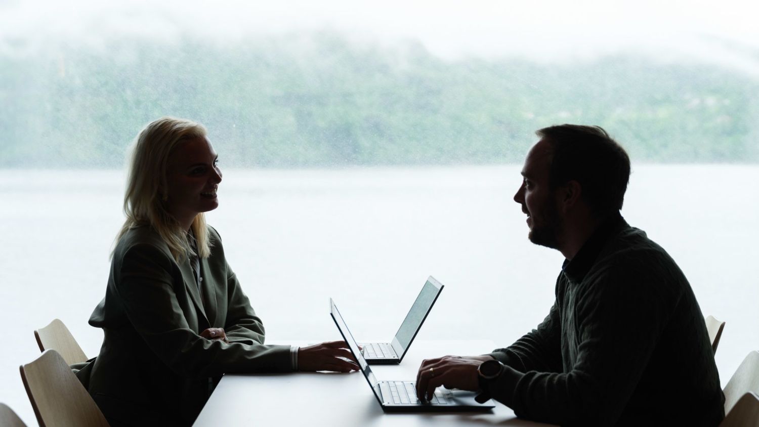 Two employees at Havila Boyages working on computer