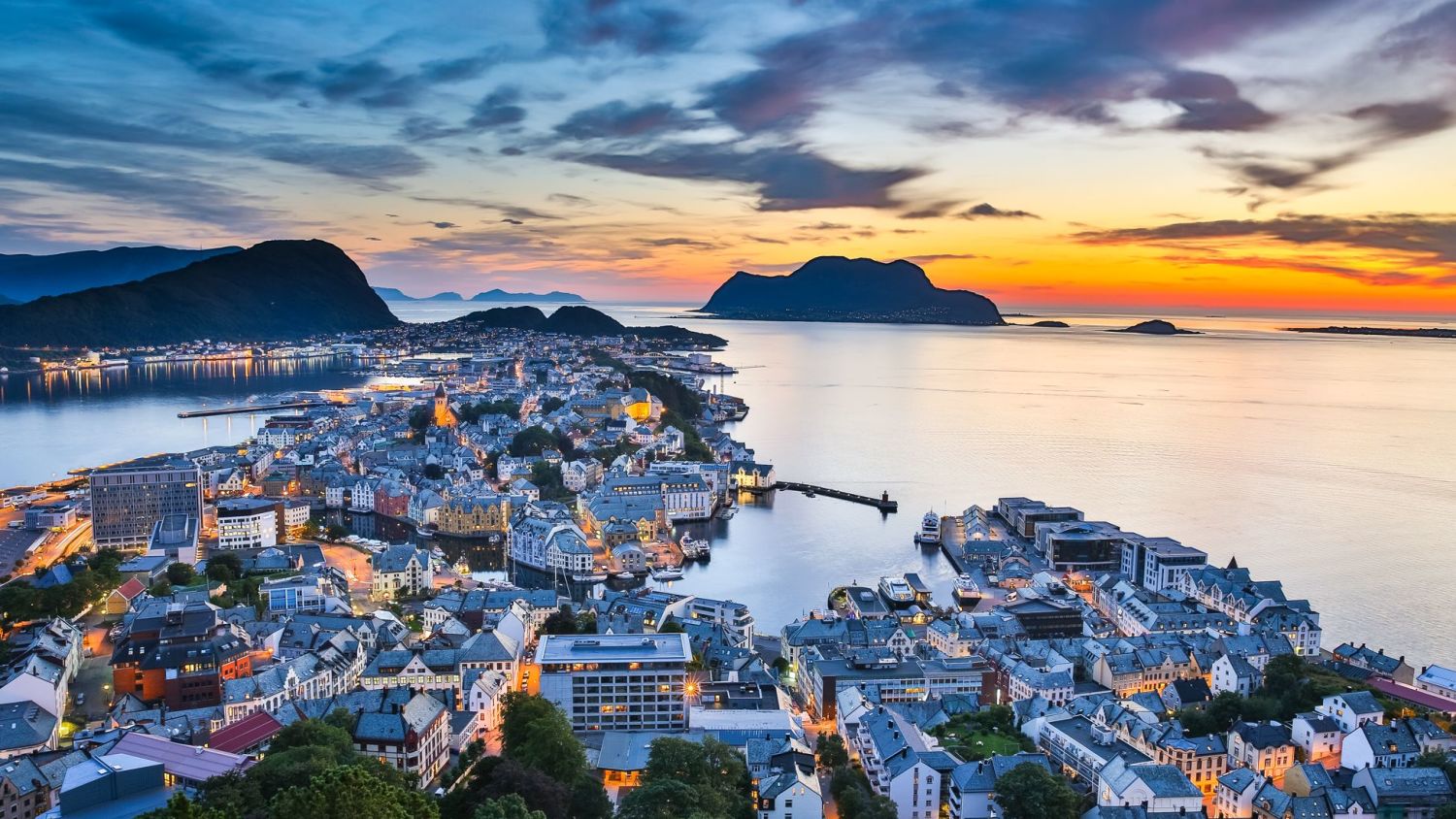 Orange sun set in the ocean outside Ålesund. 