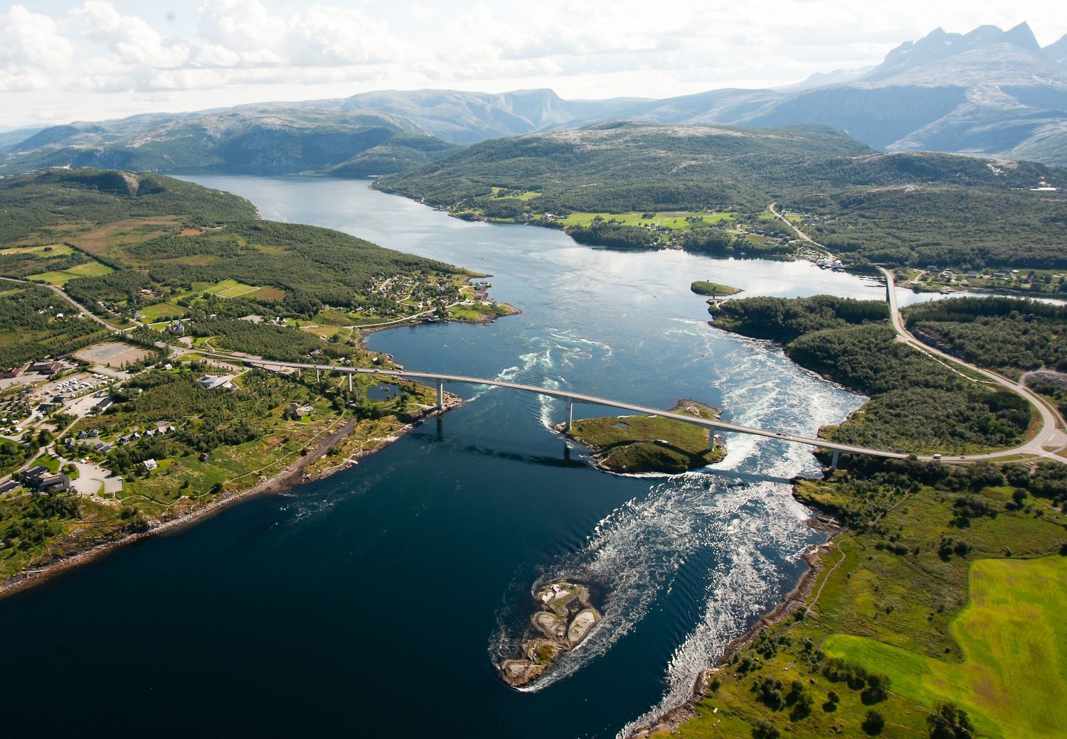 drone photo over saltstraumen with mountains in the back