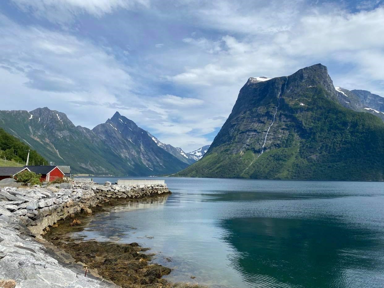 The little hamlet Urke under the steep mountains in Hjørundfjorden