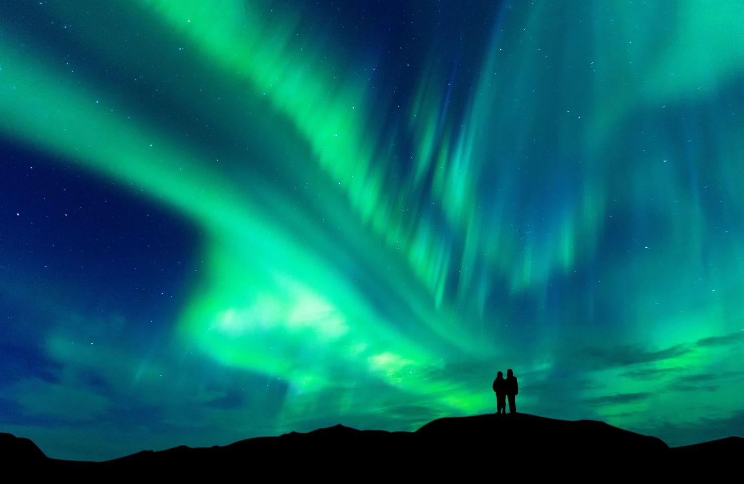 Couple enjoying the Northern Lights. 