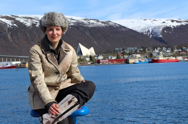 Walking theatre in Tromsø. Woman dressed in fur coat made of seal. 