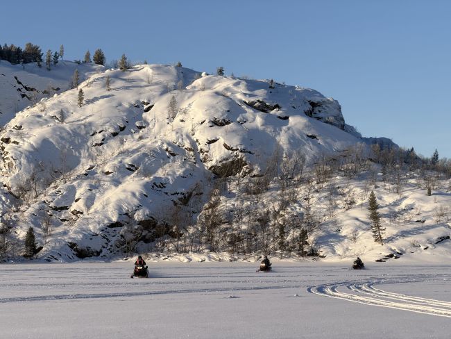 idyllic winterpicture with 3 snow scooters